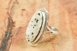 White Buffalo Turquoise set in Sterling Silver Ring. This Beautiful Stone is formed from the minerals Calcite and Iron. It is mined near Tonopah Nevada. Created by Navajo Artist Larson Lee. Signed by the artist.